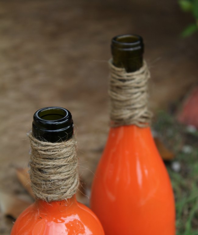 Paint wine bottle to look like pumpkins