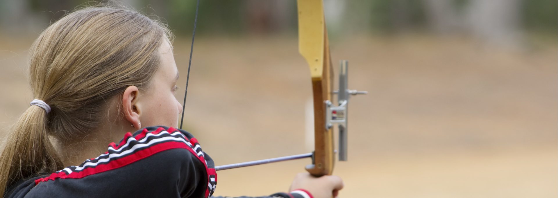 Teenaged Girl Shooting a Recurve Bow