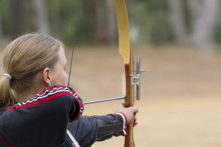 Teenaged Girl Shooting a Recurve Bow