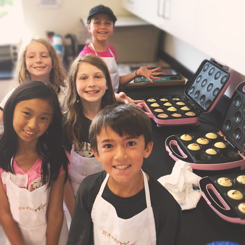 Group photo smiling with muffins