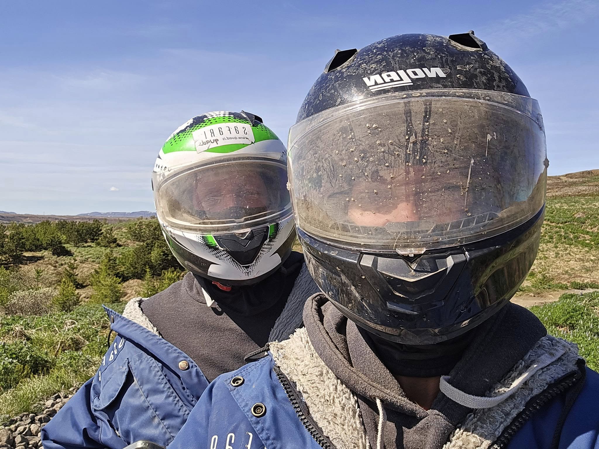 Family on ATV ride with very dirty helmets in Iceland on the mountains Family on ATV ride with very dirty helmets in Iceland on the mountains