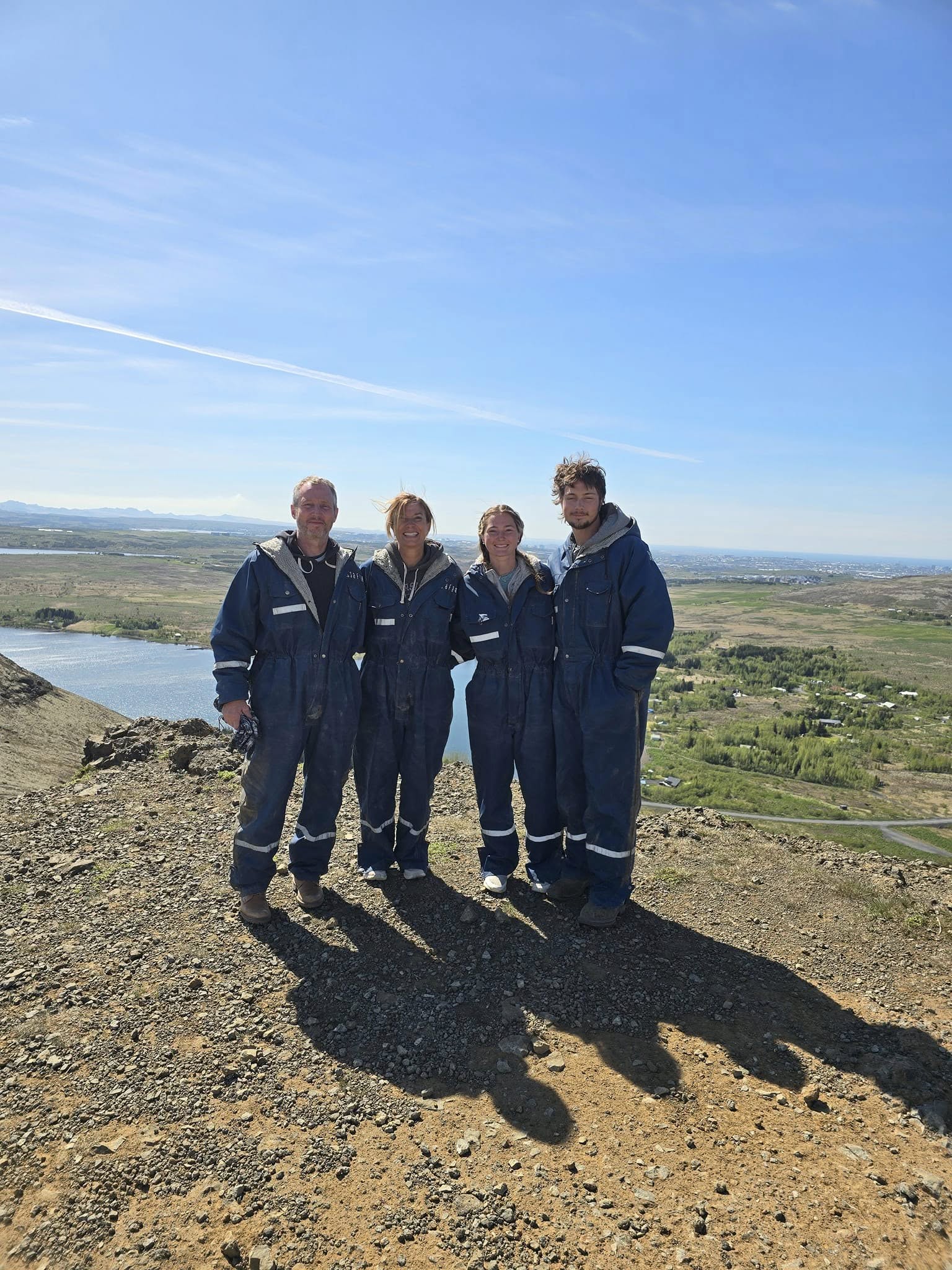 Family riding ATVs across Icelandic countryside with volcanic rocks and distant mountains. Family riding ATVs across Icelandic countryside with volcanic rocks and distant mountains.
