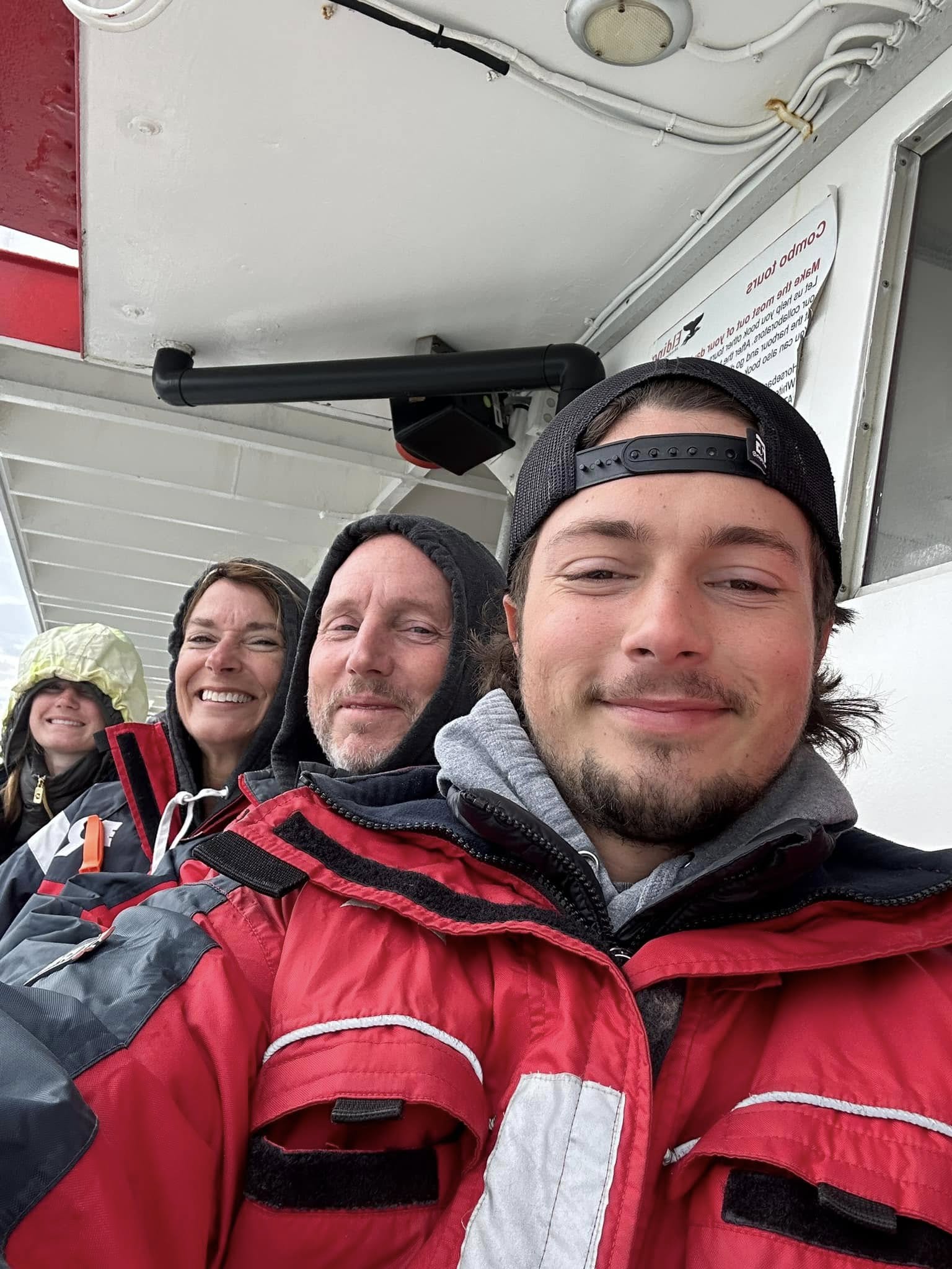Family all bundled up on a whale watching tour in Iceland. Family all bundled up on a whale watching tour in Iceland.