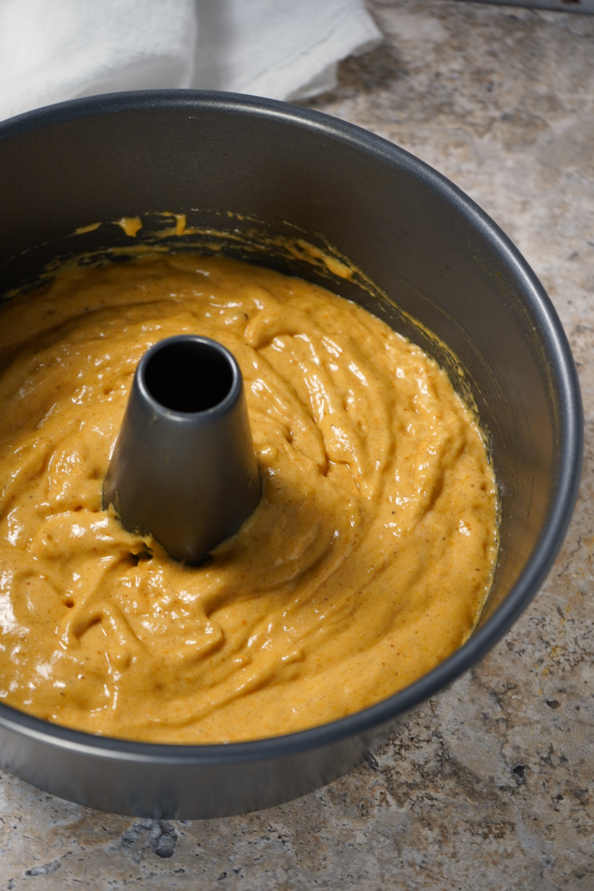 Pumpkin Angel Food Cake batter poured into angel food cake pan, ready to bake, easy WW-friendly dessert