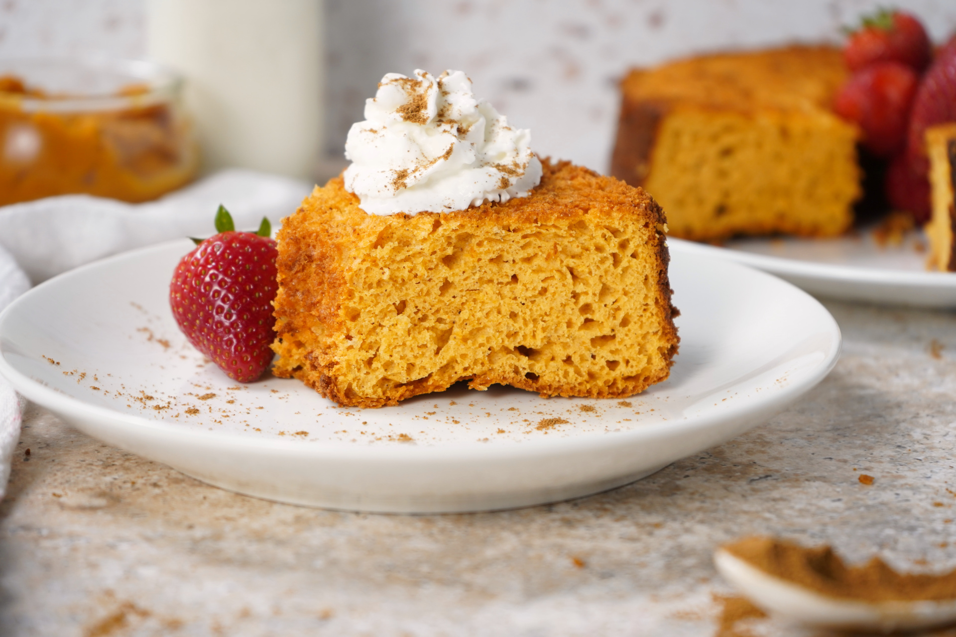 Slice of healthy Pumpkin Angel Food Cake with whipped topping, easy Weight Watchers dessert.
