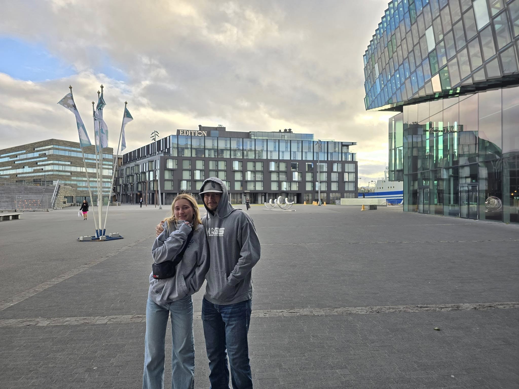 Exterior view of the Reykjavik EDITION hotel with mountains and ocean in the distance. Exterior view of the Reykjavik EDITION hotel with mountains and ocean in the distance.