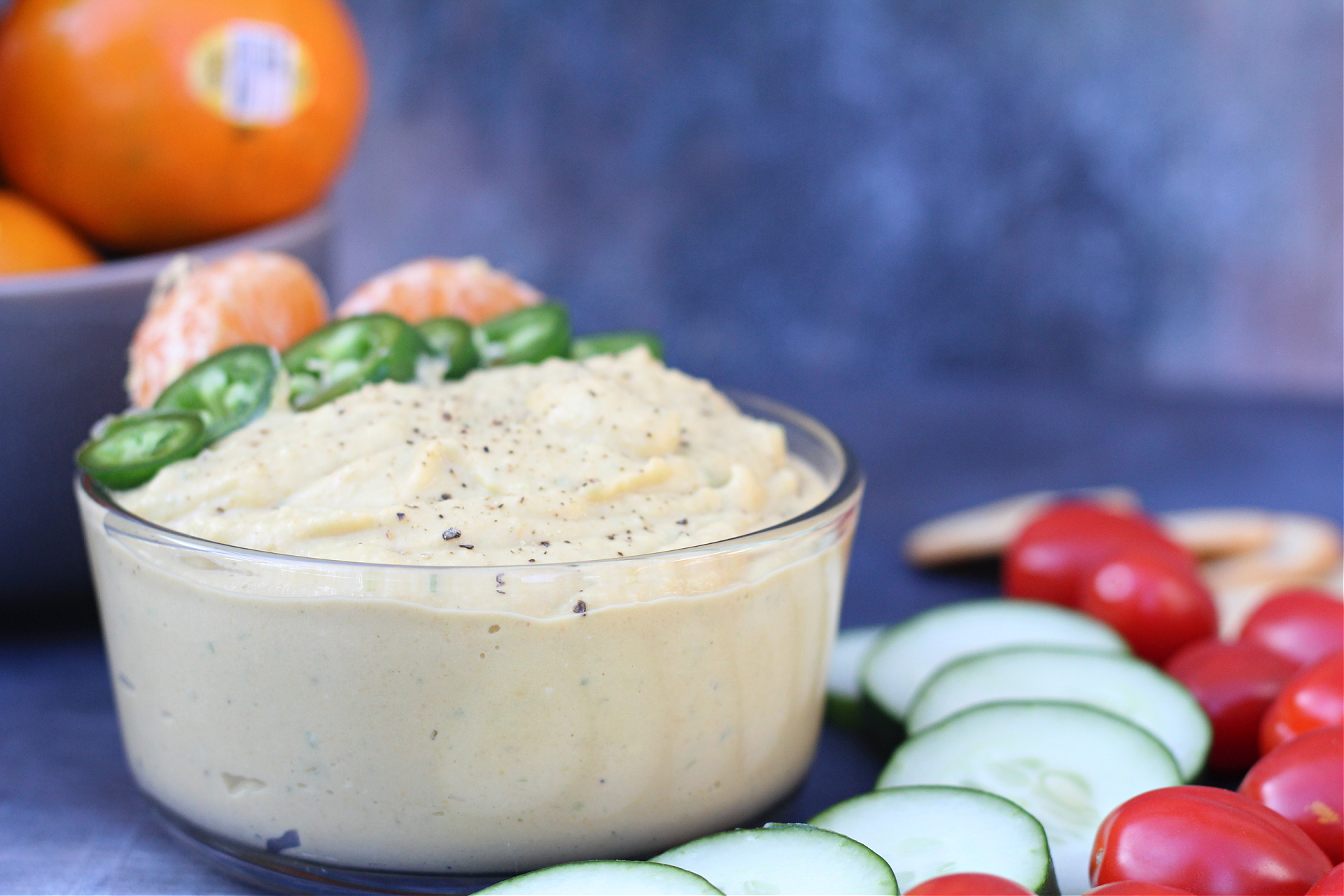 Bowl full of tangerine hummus showing smooth, creamy texture. Bowl full of tangerine hummus showing smooth, creamy texture.