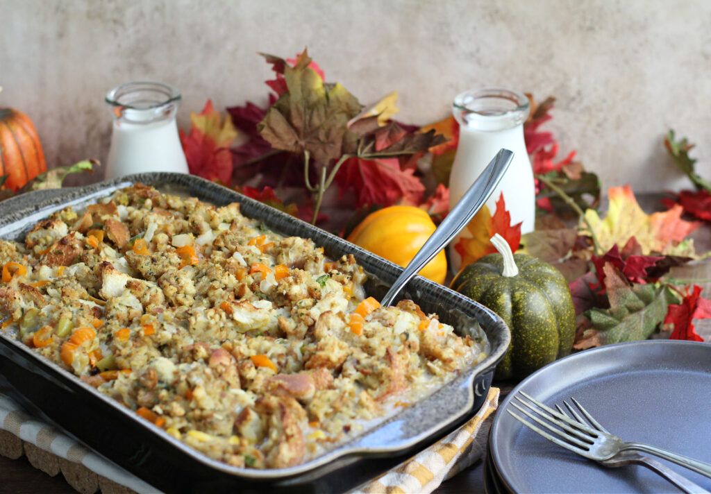 Baked Thanksgiving Leftover Casserole ready to serve, with fall decorations around the table.
