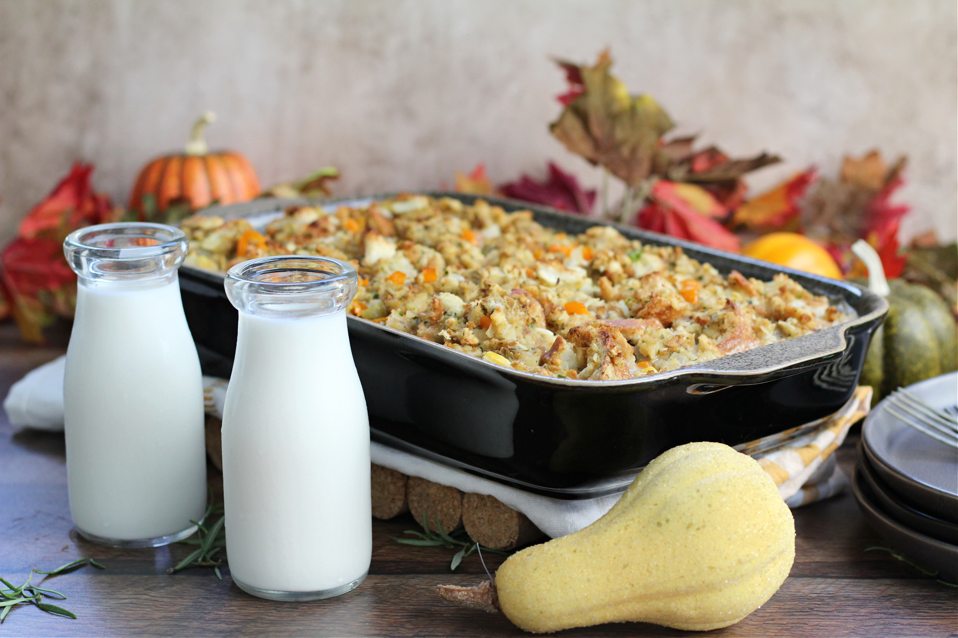 Baked Thanksgiving Leftover Casserole in a 9&times;13 pan, golden on top, ready to serve with a glass of milk.