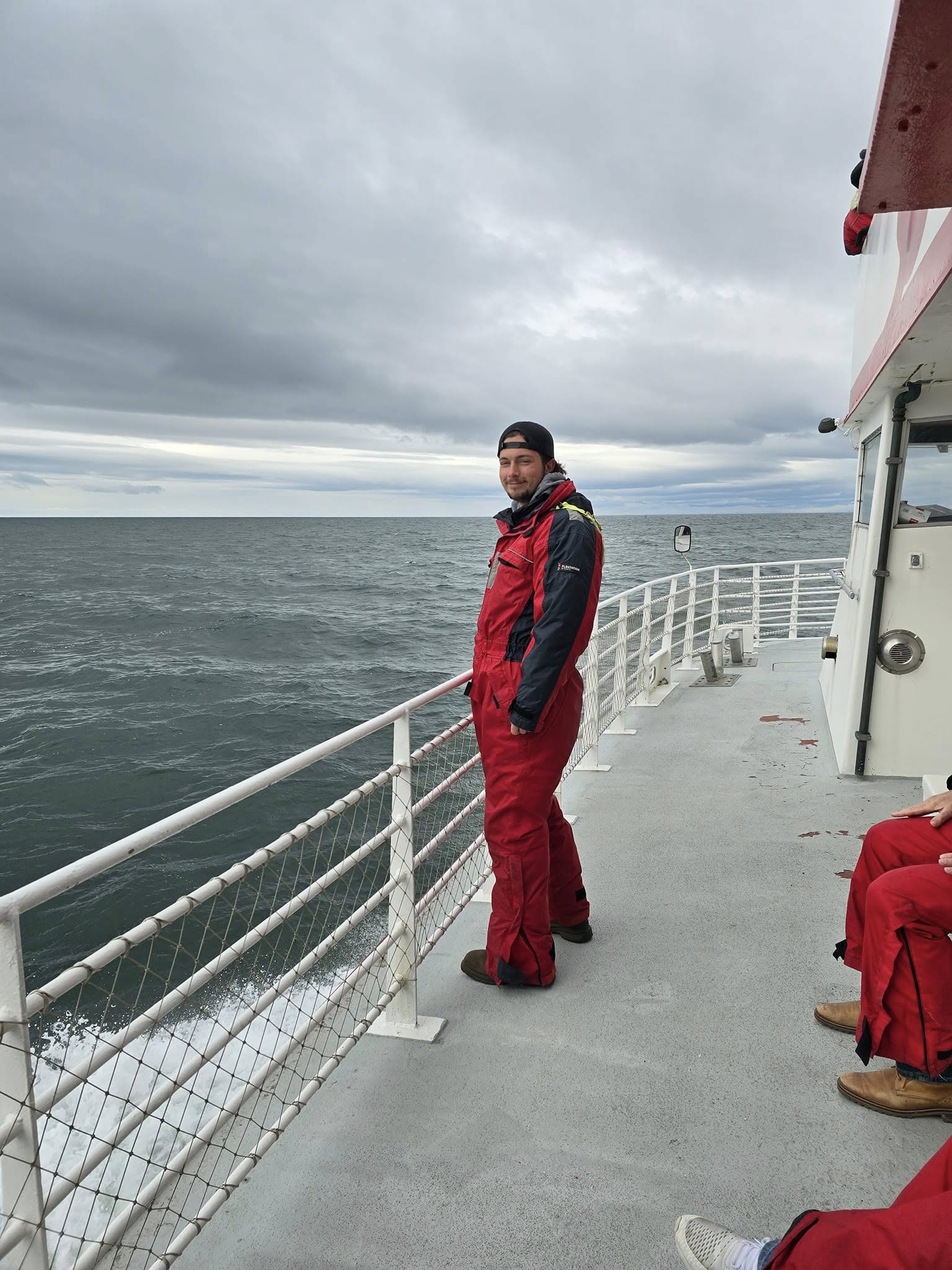 Tour boat in Iceland on a windy day during whale watching, with puffins flying nearby. Tour boat in Iceland on a windy day during whale watching, with puffins flying nearby.