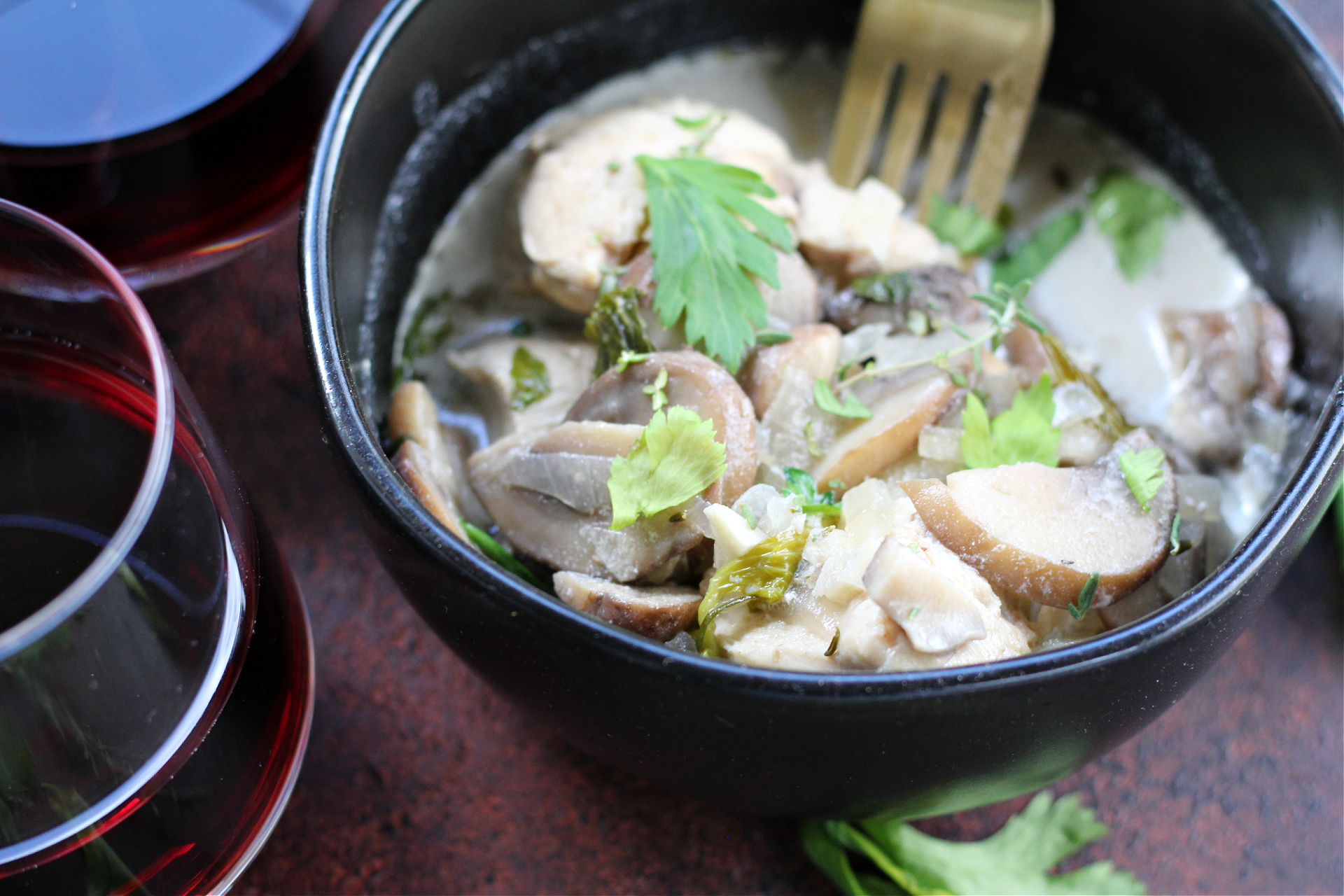 Homemade chicken and mushroom fricassee with onions, garlic, and fresh herbs