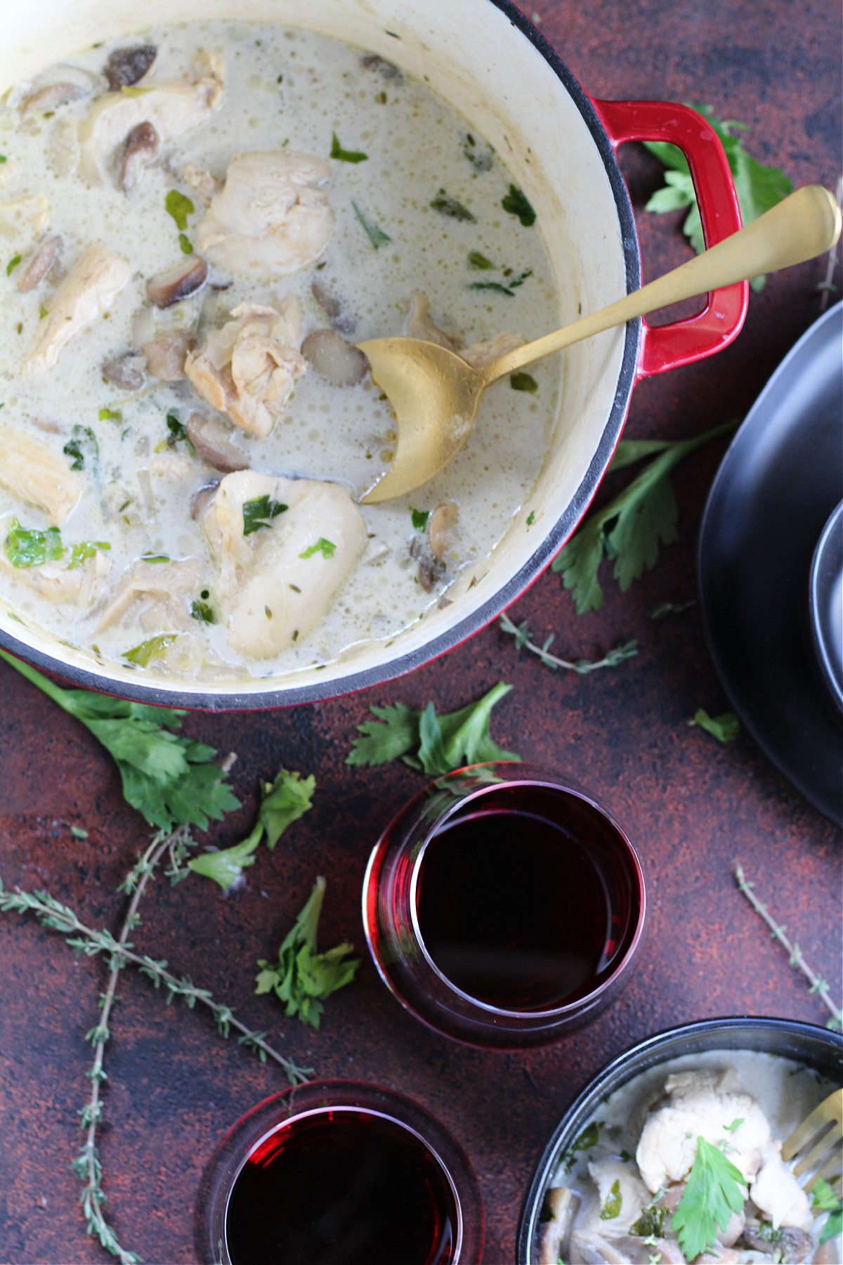 One pot chicken and mushroom fricassee garnished with celery leaves and herbs