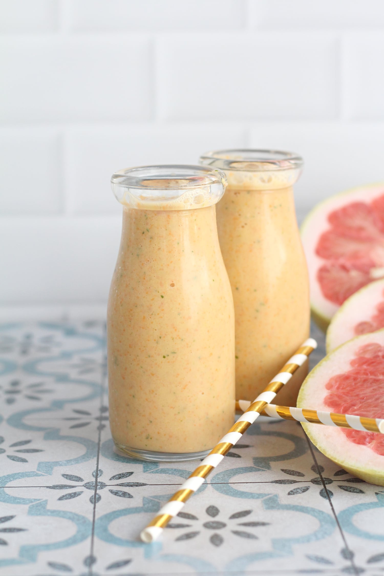 Two Glasses of Florida citrus smoothie with two gold straws. Two Glasses of Florida citrus smoothie with two gold straws.