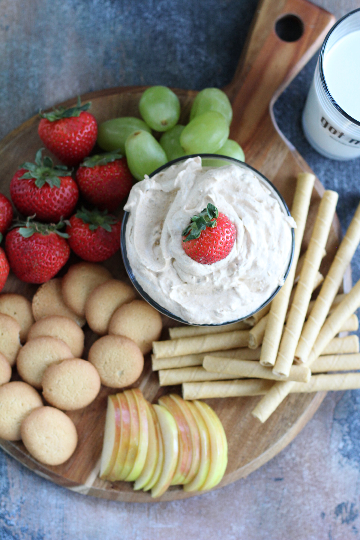 Pumpkin fluff dessert on a fall-inspired table with fruit and cracker dippers.