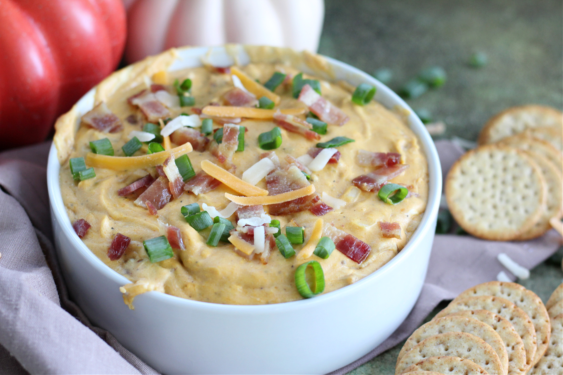 Best Pumpkin and Bacon Dip Appetizer Creamy savory pumpkin dip with bacon and cheese surrounded by crackers for dipping