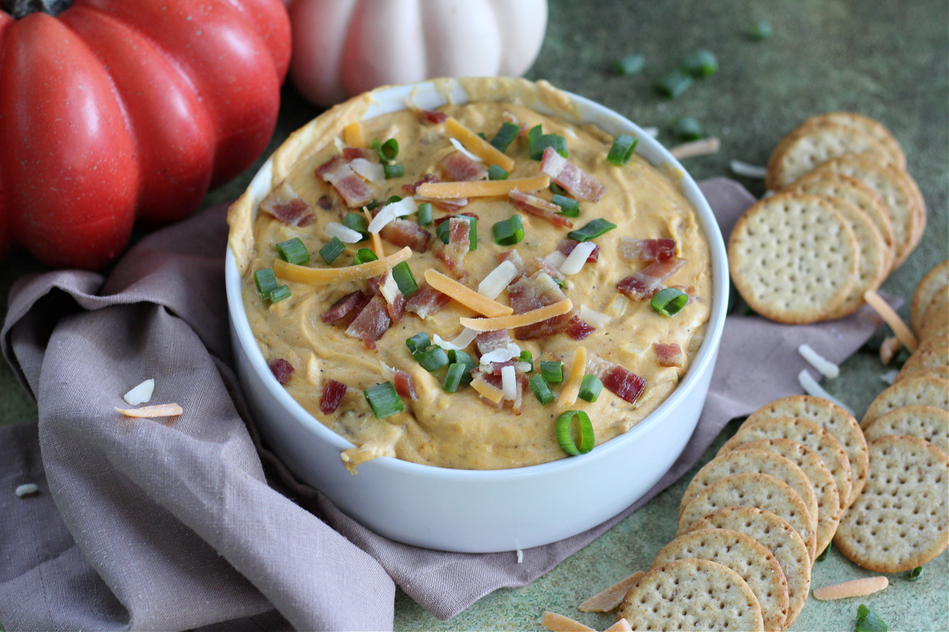 Tasty Pumpkin and Bacon Dip Appetizer Close-up of baked pumpkin dip showing melted cheddar and crispy bacon pieces