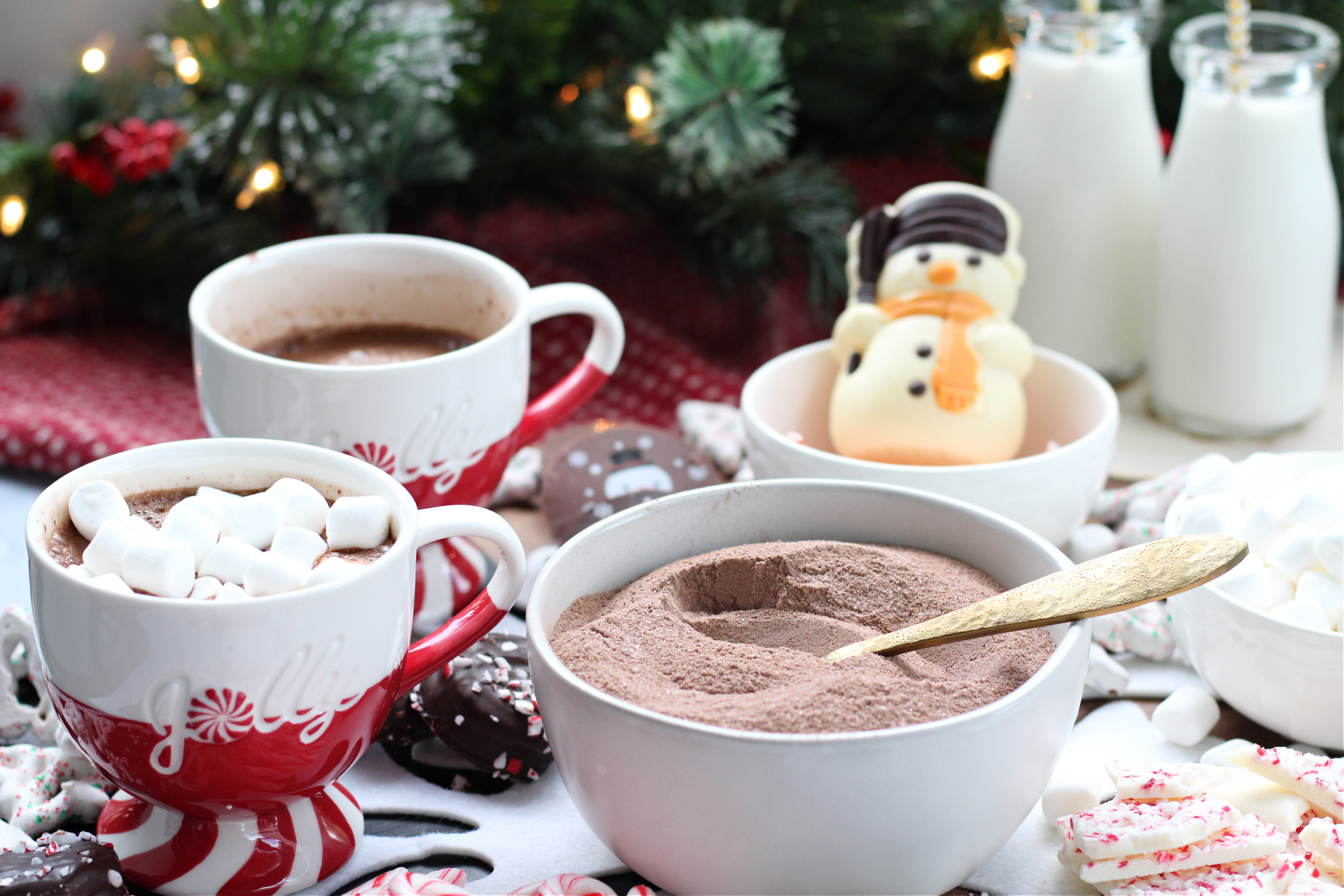 Close-up of a peppermint hot chocolate board featuring snowman cocoa toppers and candy.