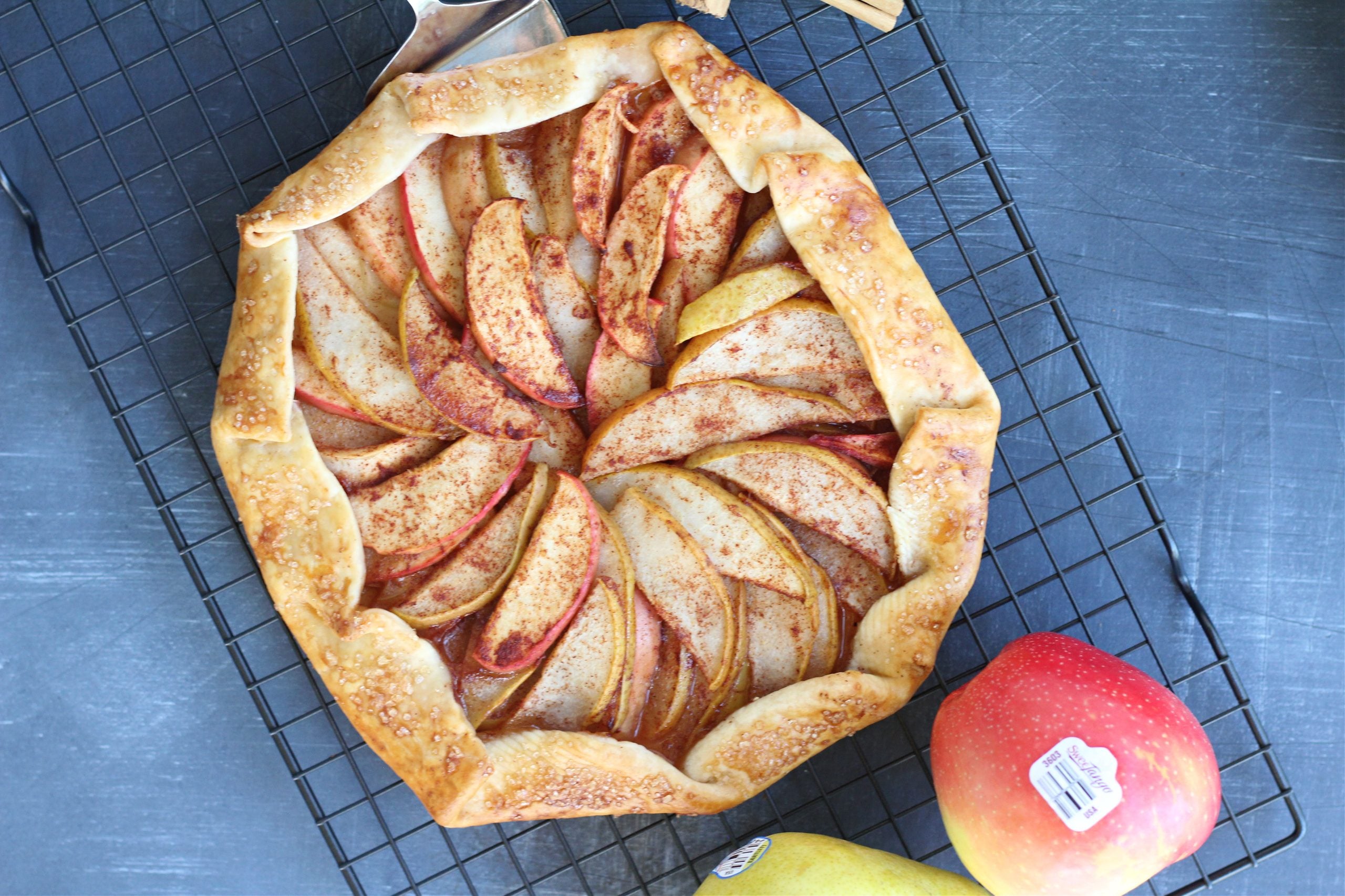 Top-down view of apple and pear galette with autumn colors and crispy edges.