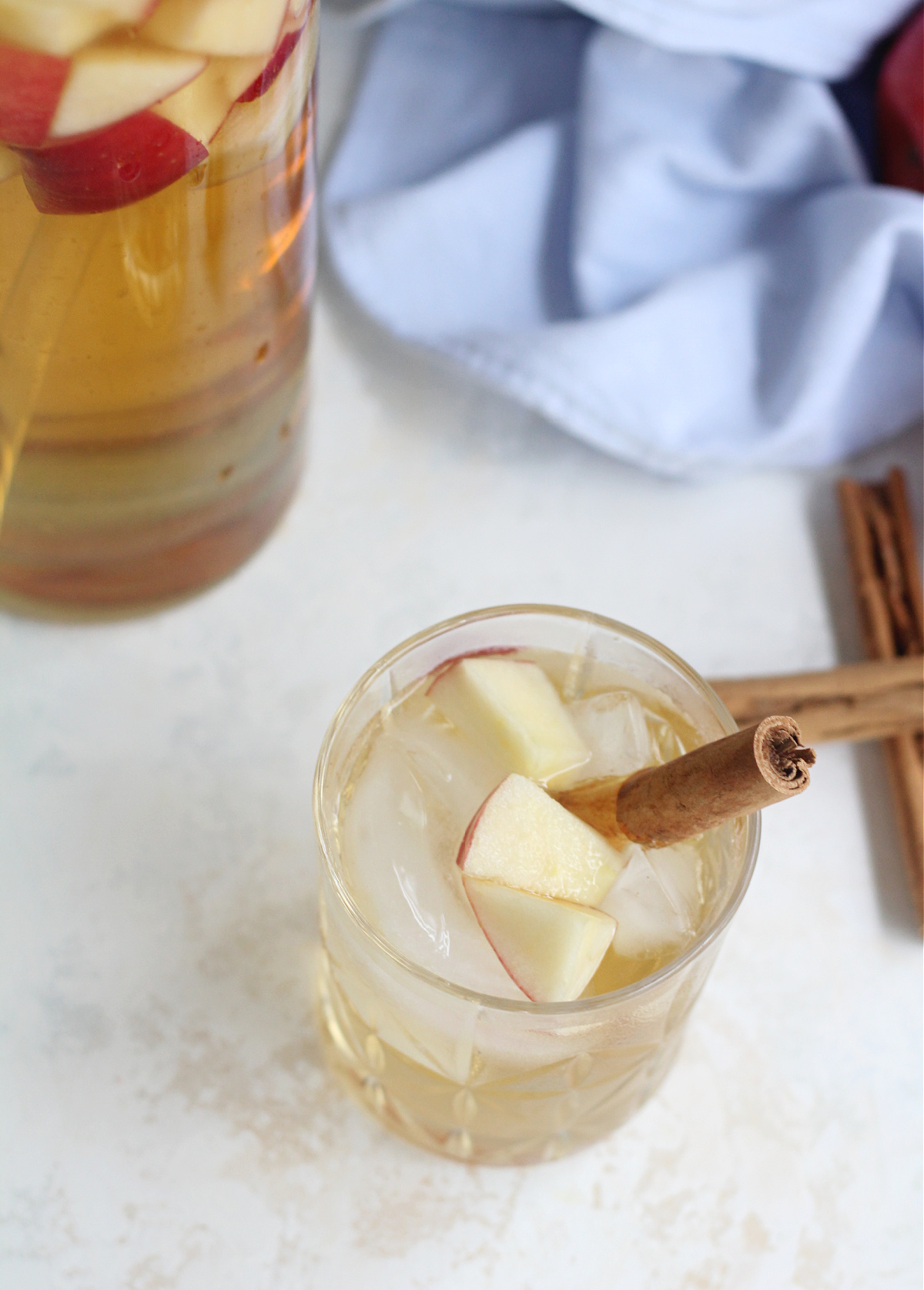 Close-up of a chilled apple sangria in a glass with fresh apple slices.