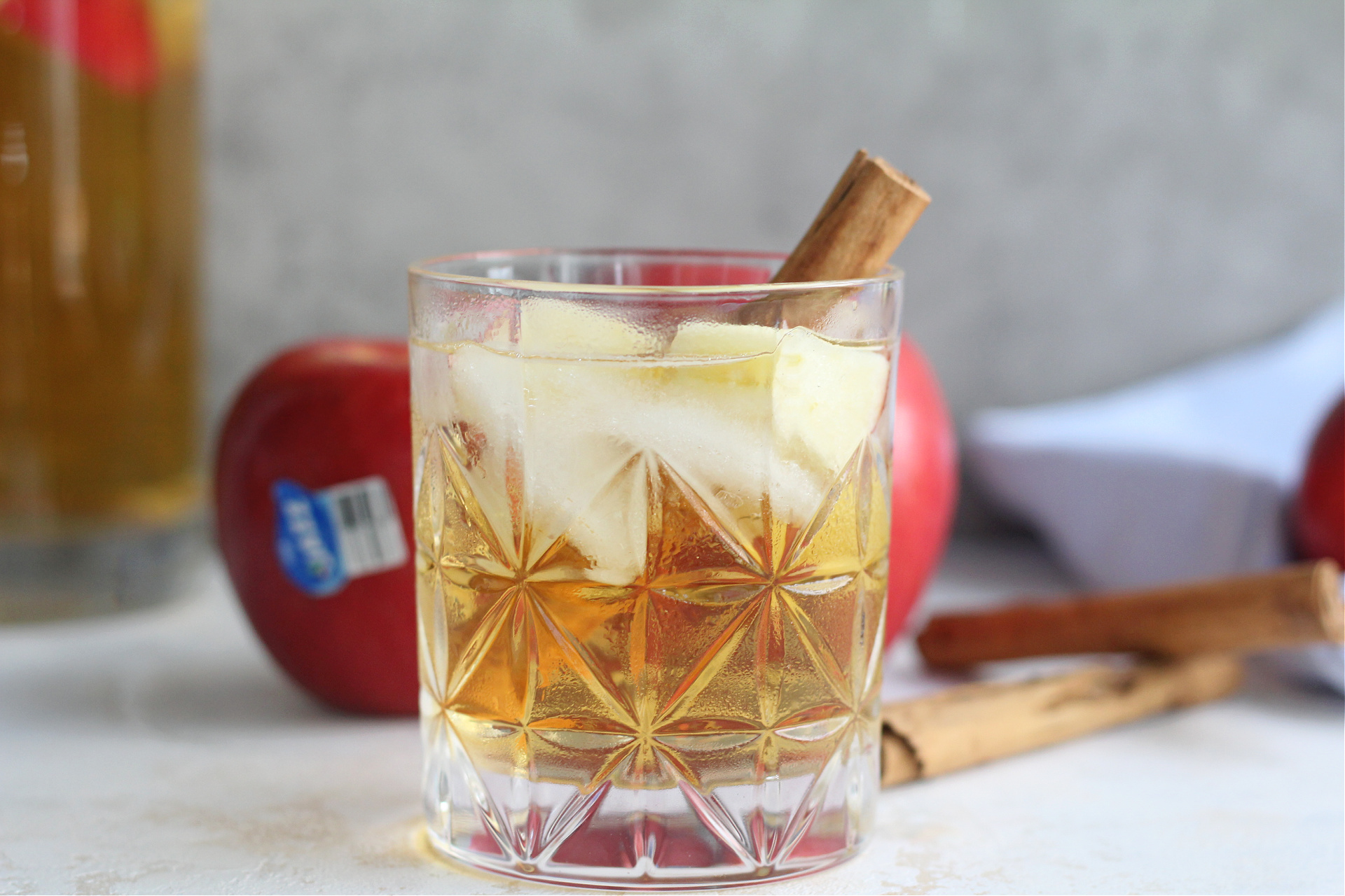 Close-up of glass of chilled apple sangria with JAZZ apples in the background.