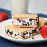 Close-up of strawberry chocolate chip ice cream sandwiches made with graham crackers.