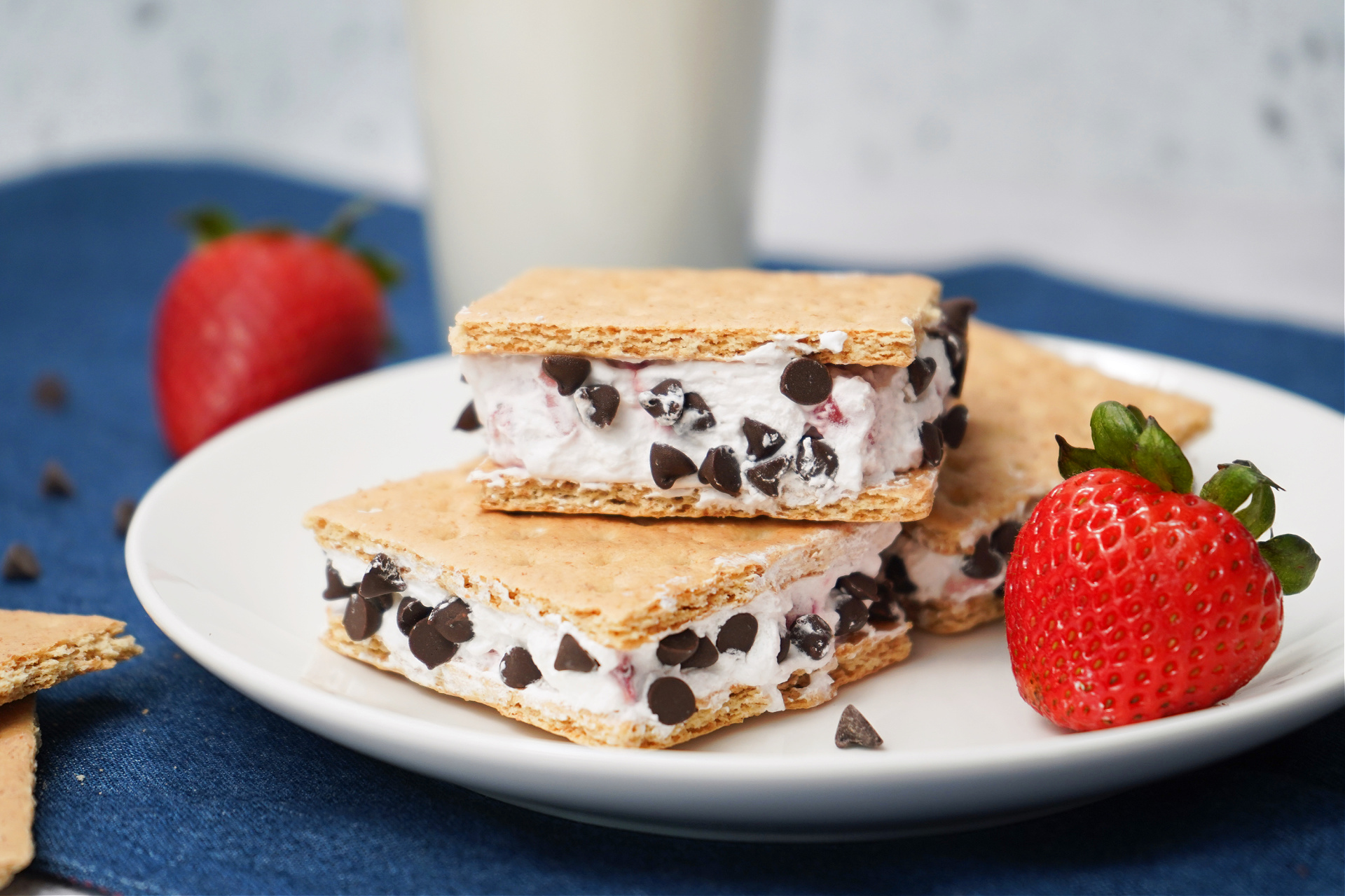 Close-up of strawberry chocolate chip ice cream sandwiches made with graham crackers.