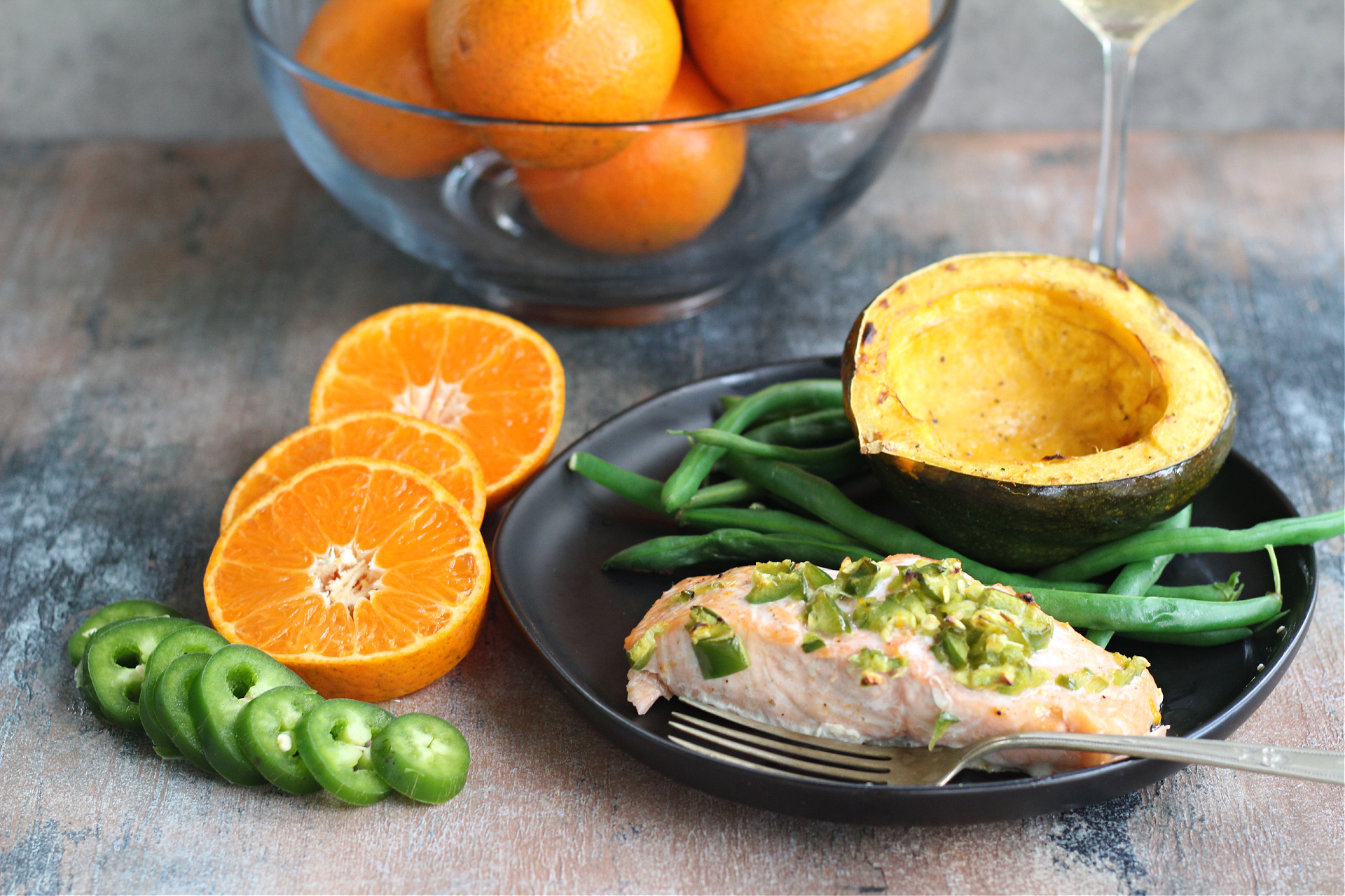 Baked citrus glazed salmon with a tangerine jalapeño sauce on a plate.