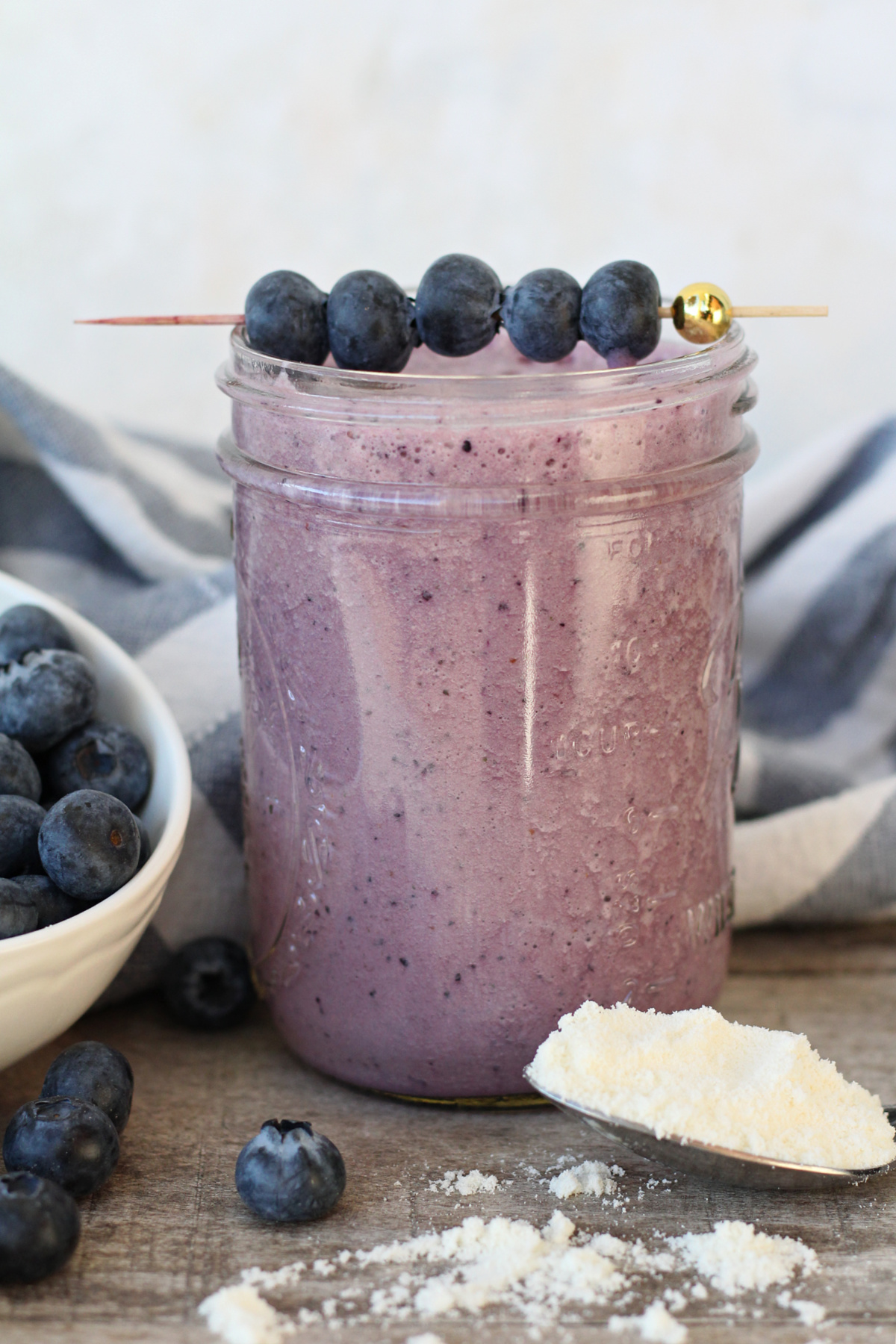Purple beet and blueberry smoothie with fruit garnish