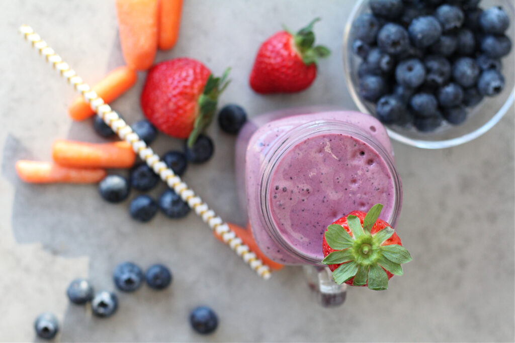 Healthy carrot blueberry smoothie made with strawberries and leafy greens