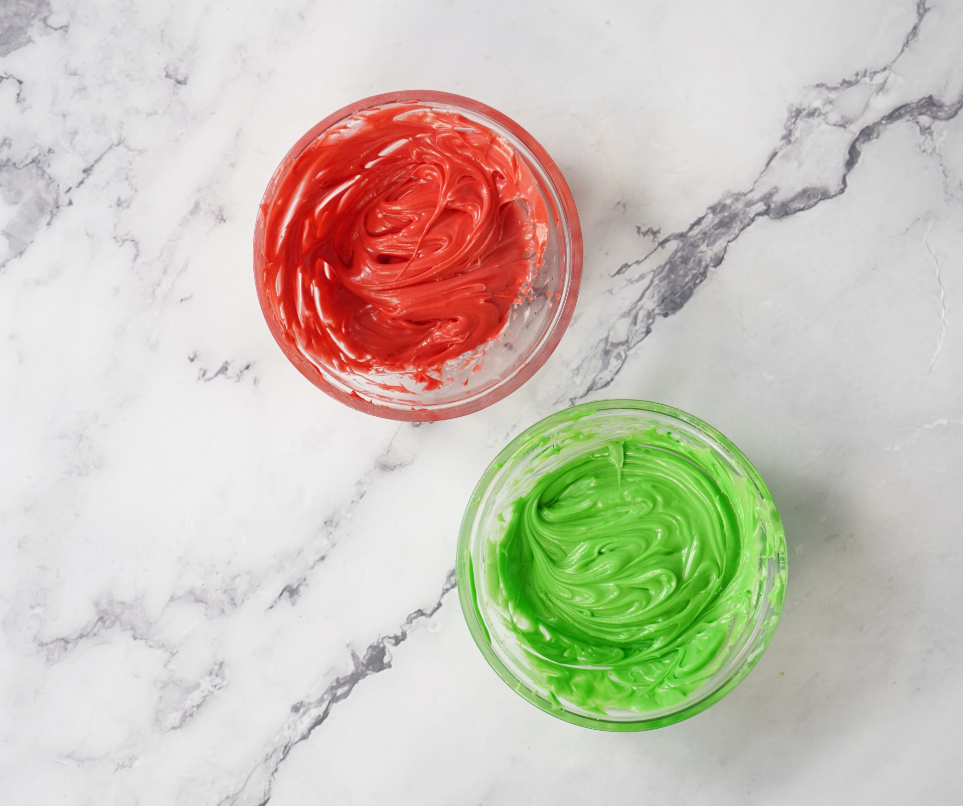 Red and green icing for decorating Christmas sugar cookies