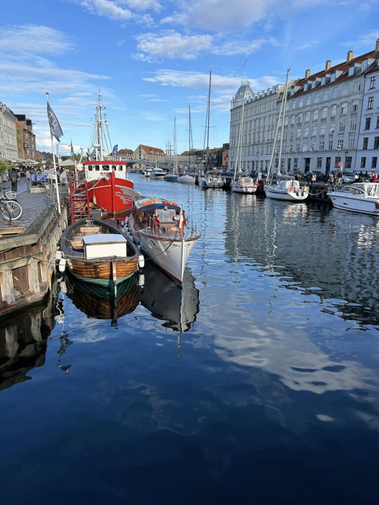 Walking along colorful canals in Copenhagen on a sunny day