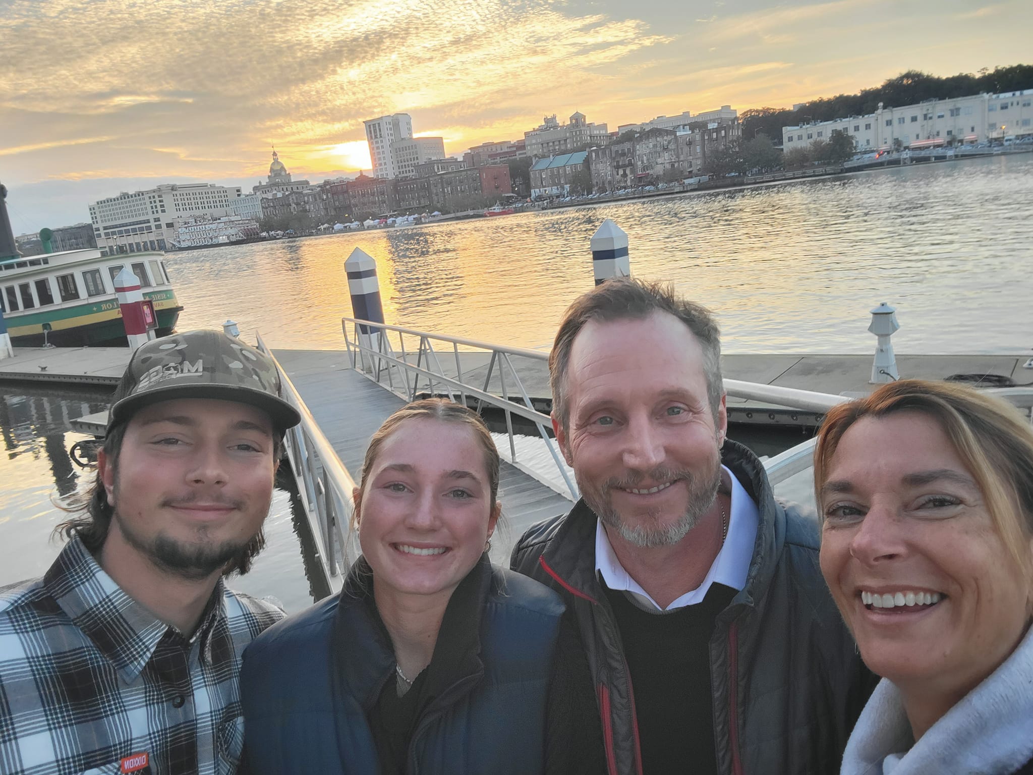 Family enjoying a walk along River Street during a weekend trip to Savannah with views of the historic riverfront.