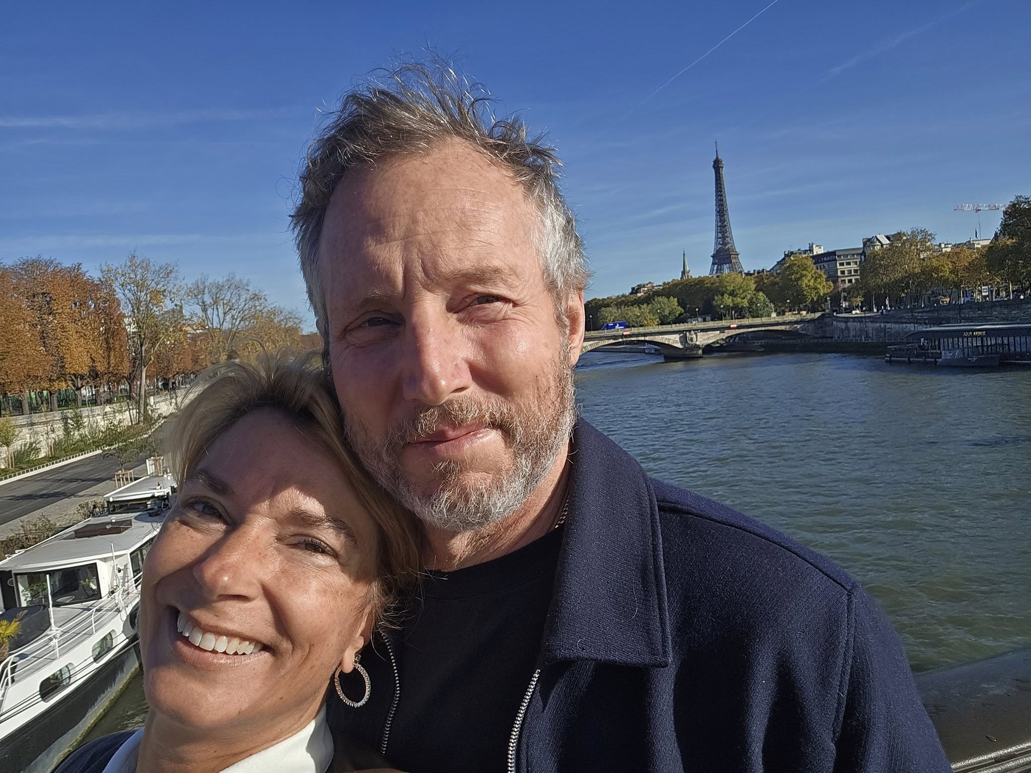 Couple along the Seine River with the Eiffel Tower in the background