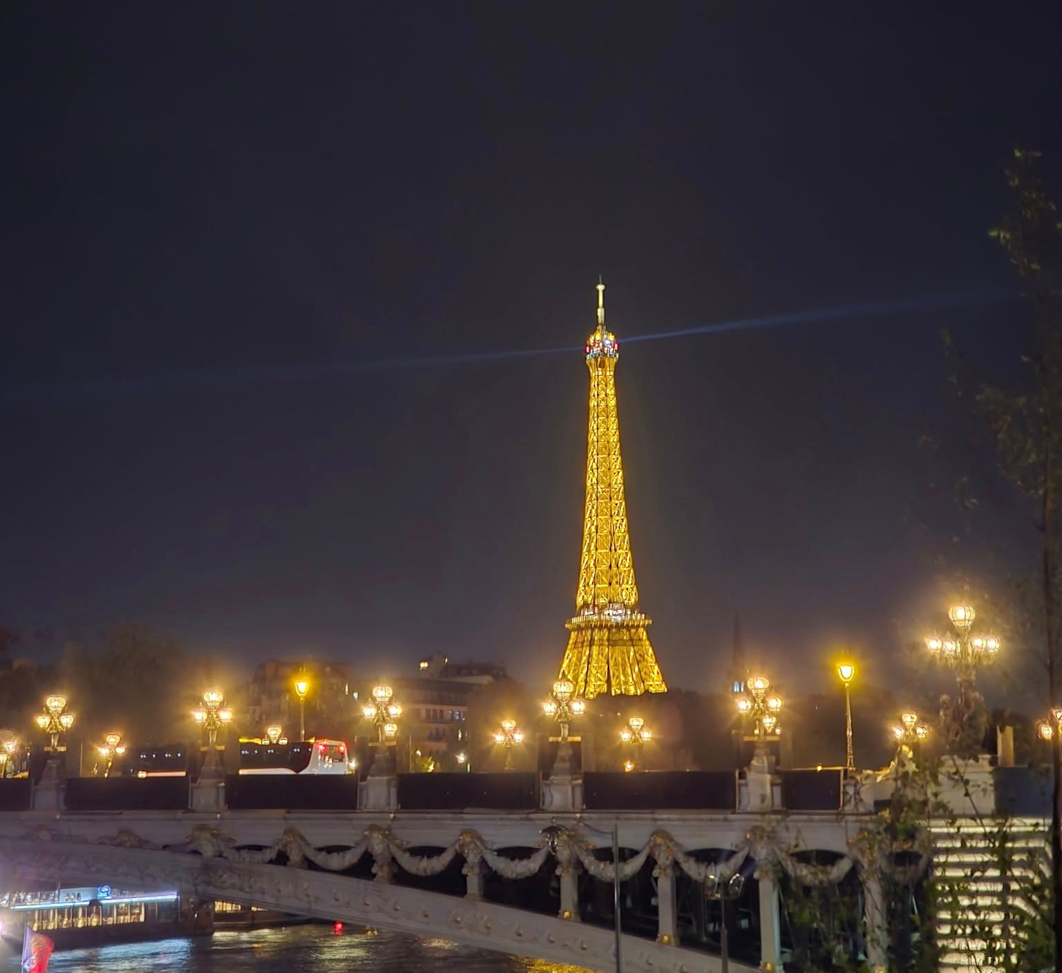 Eiffel Tower sparkling at night in Paris with city lights