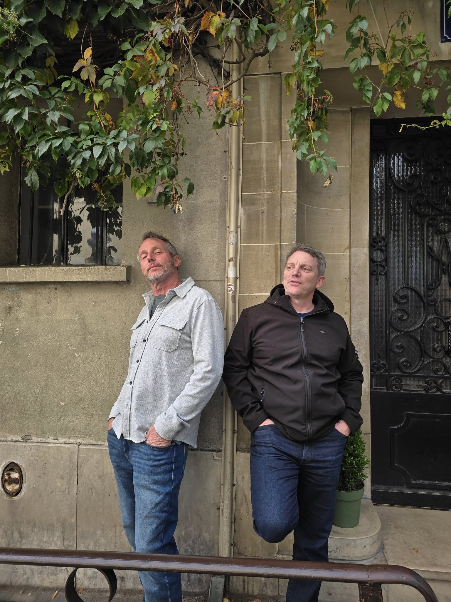 Men posing on Montmartre Paris cobblestone streets with artists and caf&eacute;s