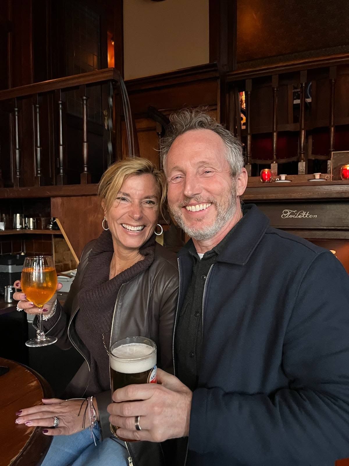 Couple enjoying drinks at a cozy pub in Amsterdam