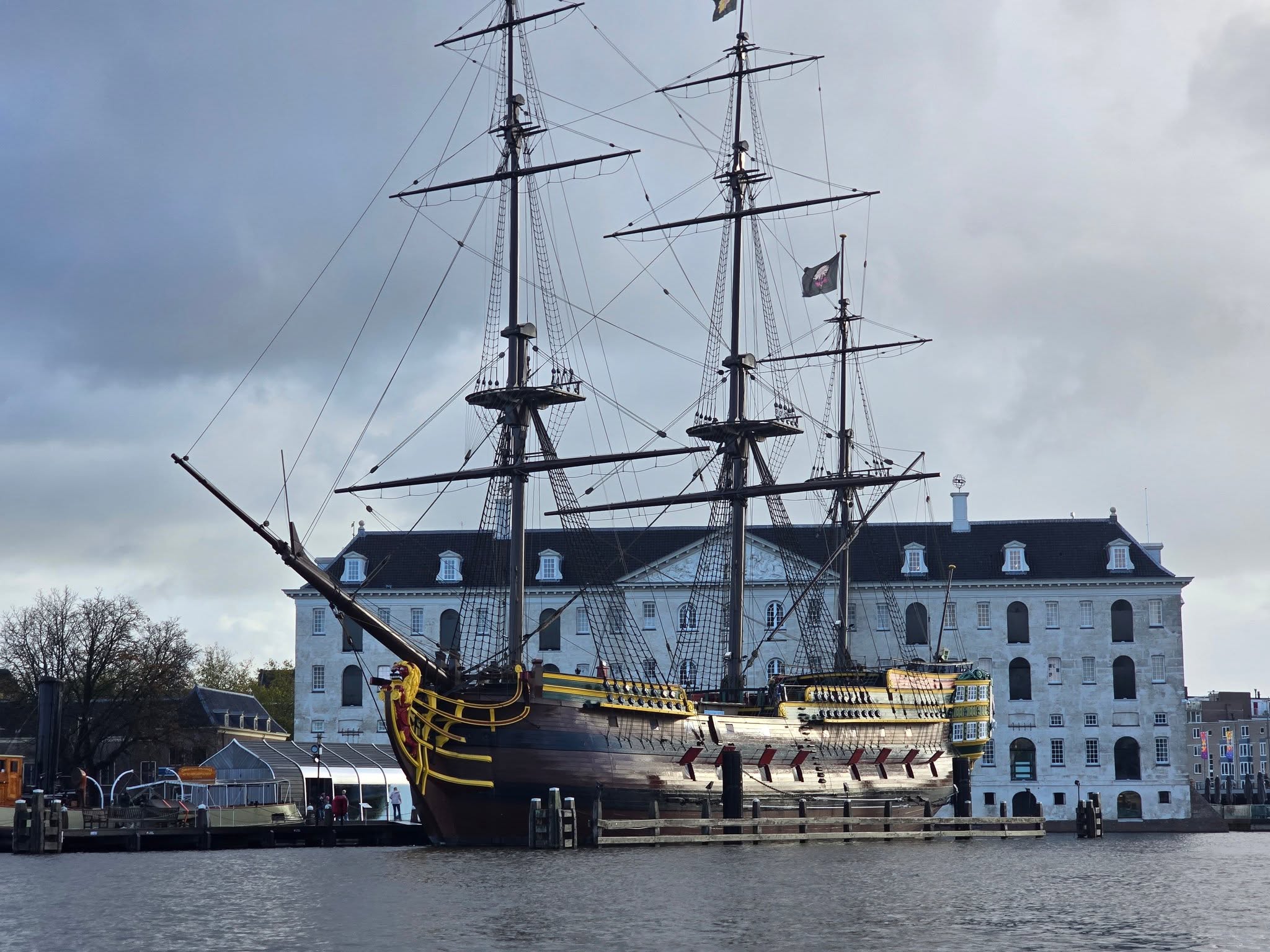View of Amsterdam historic ships from a canal boat