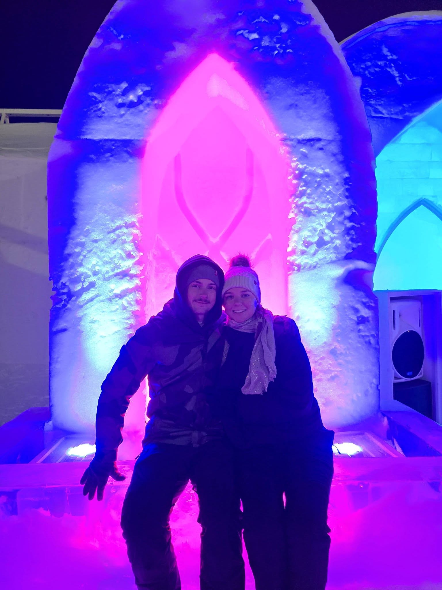 Couple sitting in front of ice sculpture at Hotel de Glace