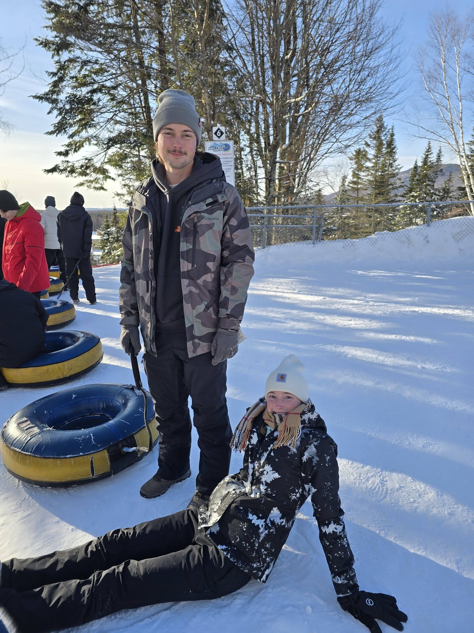 Family waiting in line to snow tube at a winter park near Quebec