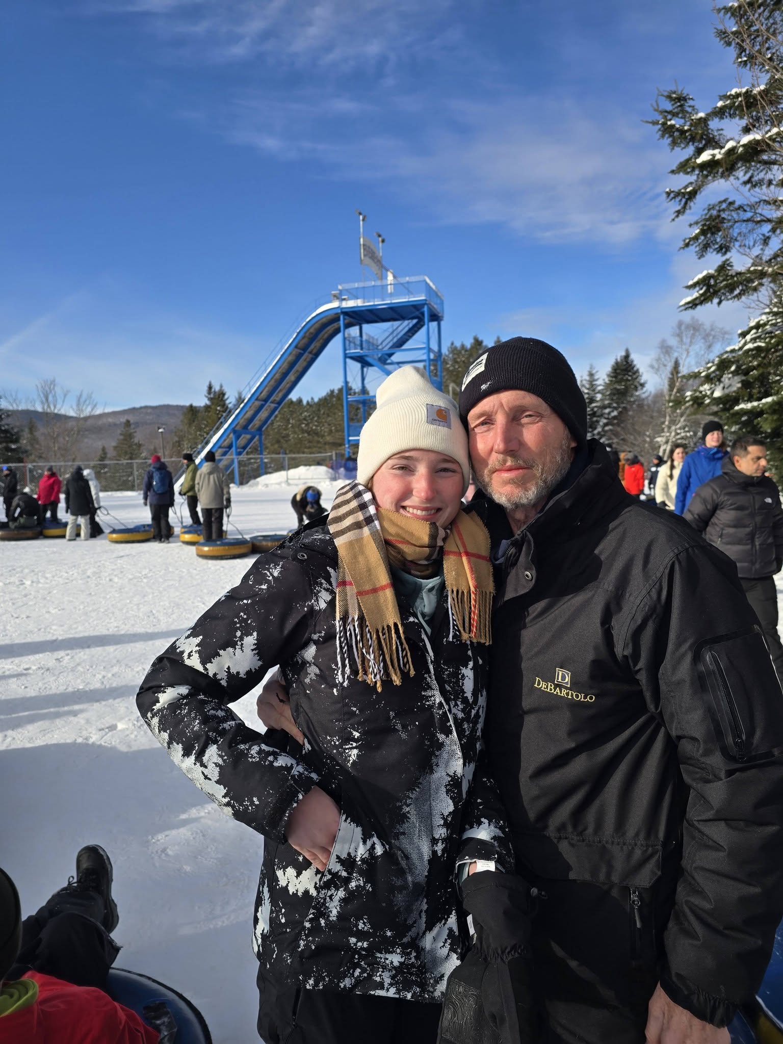 Father and daughter snow tubing near Quebec City