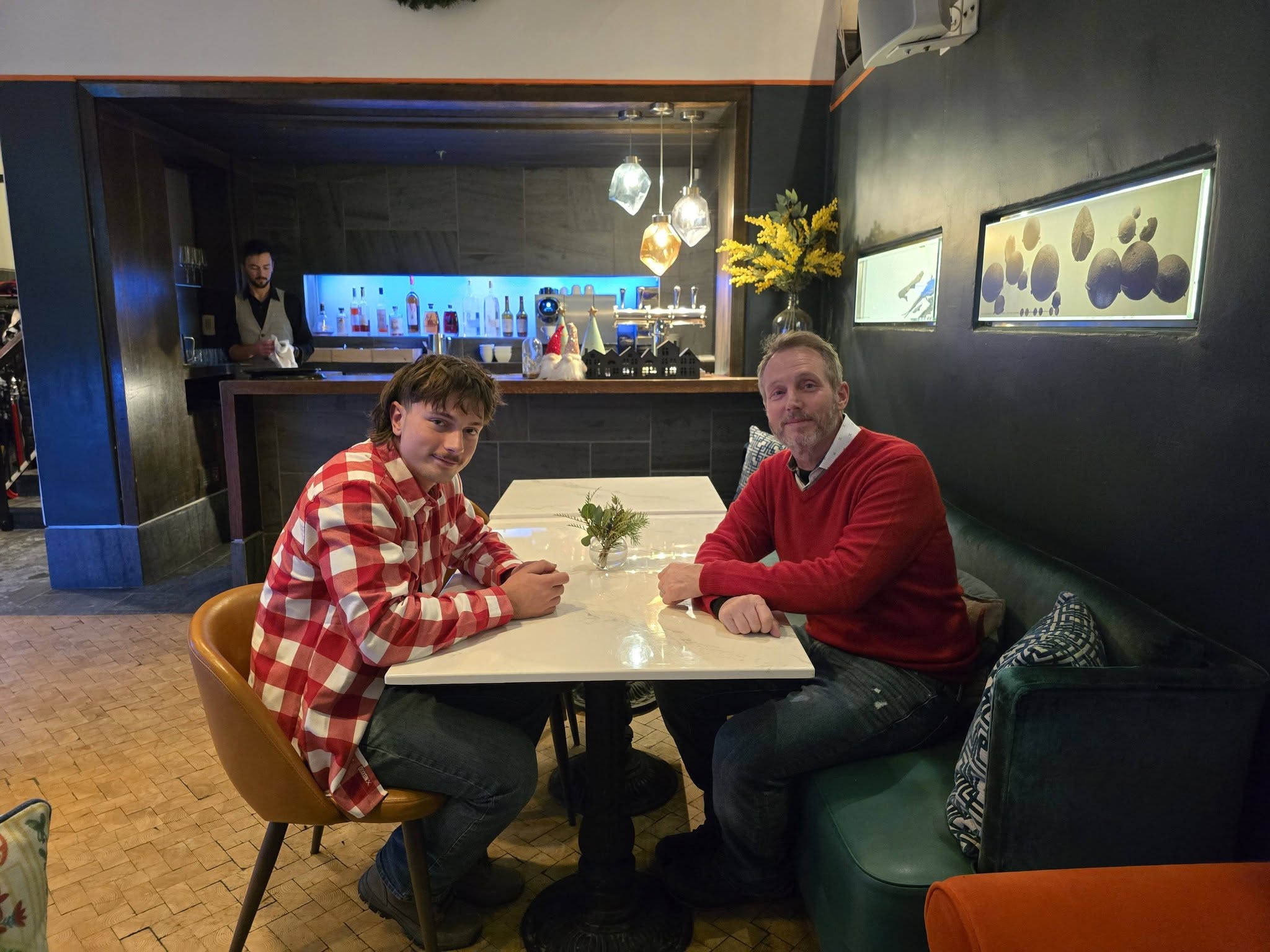 Father and son at bar Auberge Saint-Antoine in Quebec City