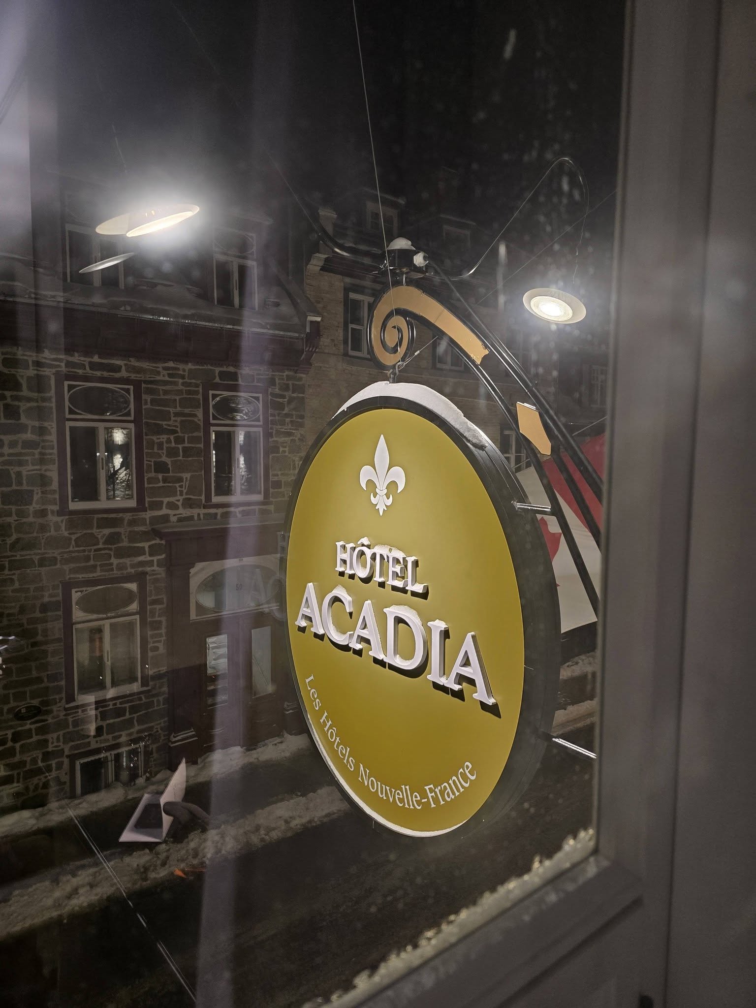 Hotel Acadia sign through the hotel room window in Quebec City