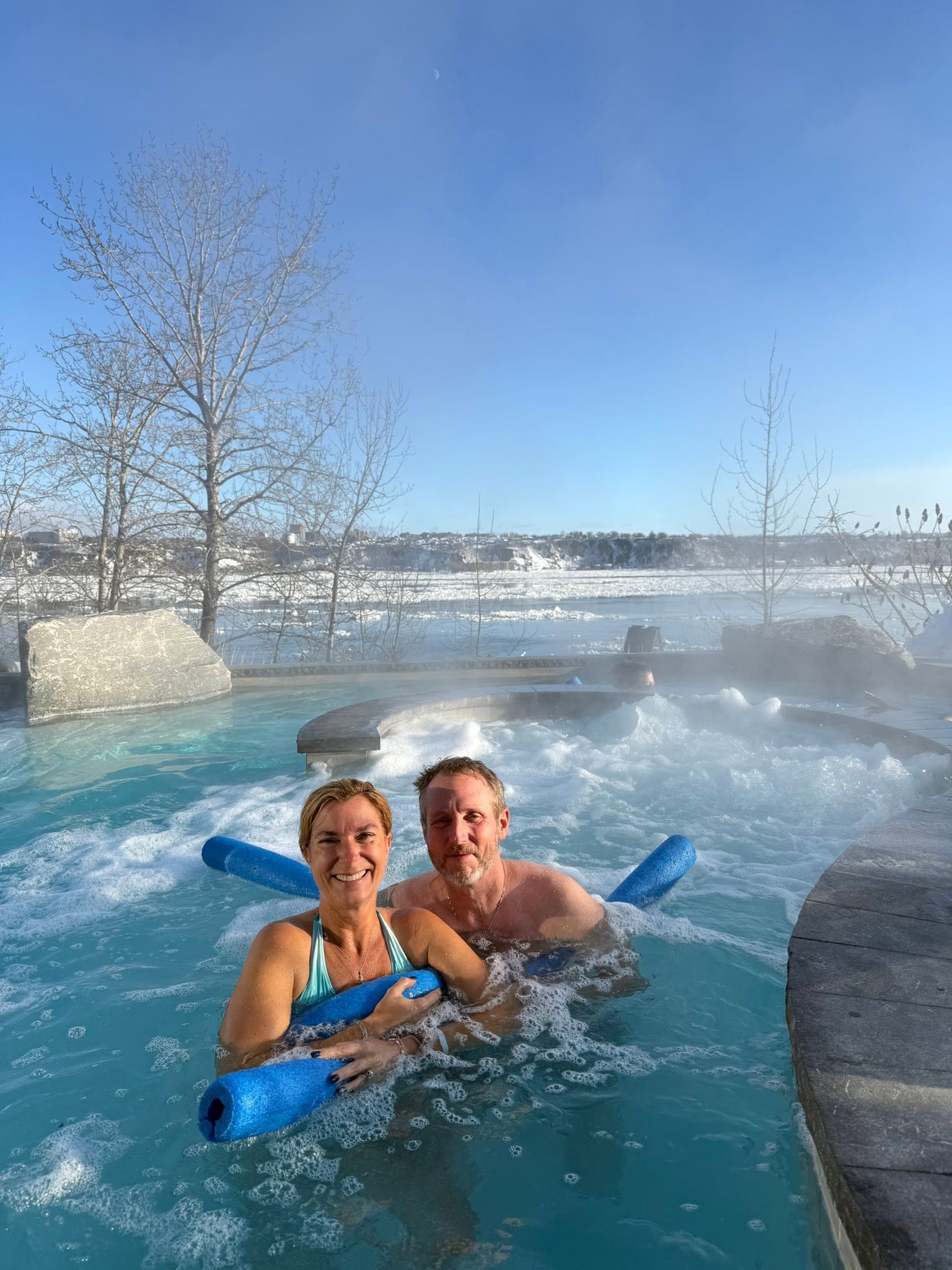 Relaxing in a hot pool surrounded by snow at Strøm Nordic Spa Québec City