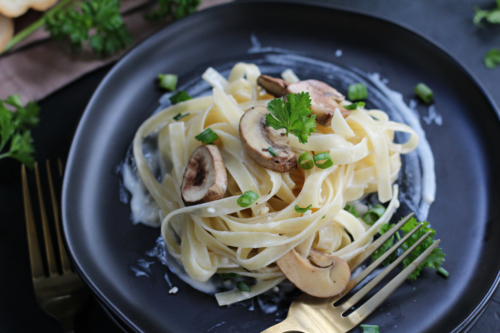 Easy homemade Alfredo sauce with sautéed mushrooms served over pasta