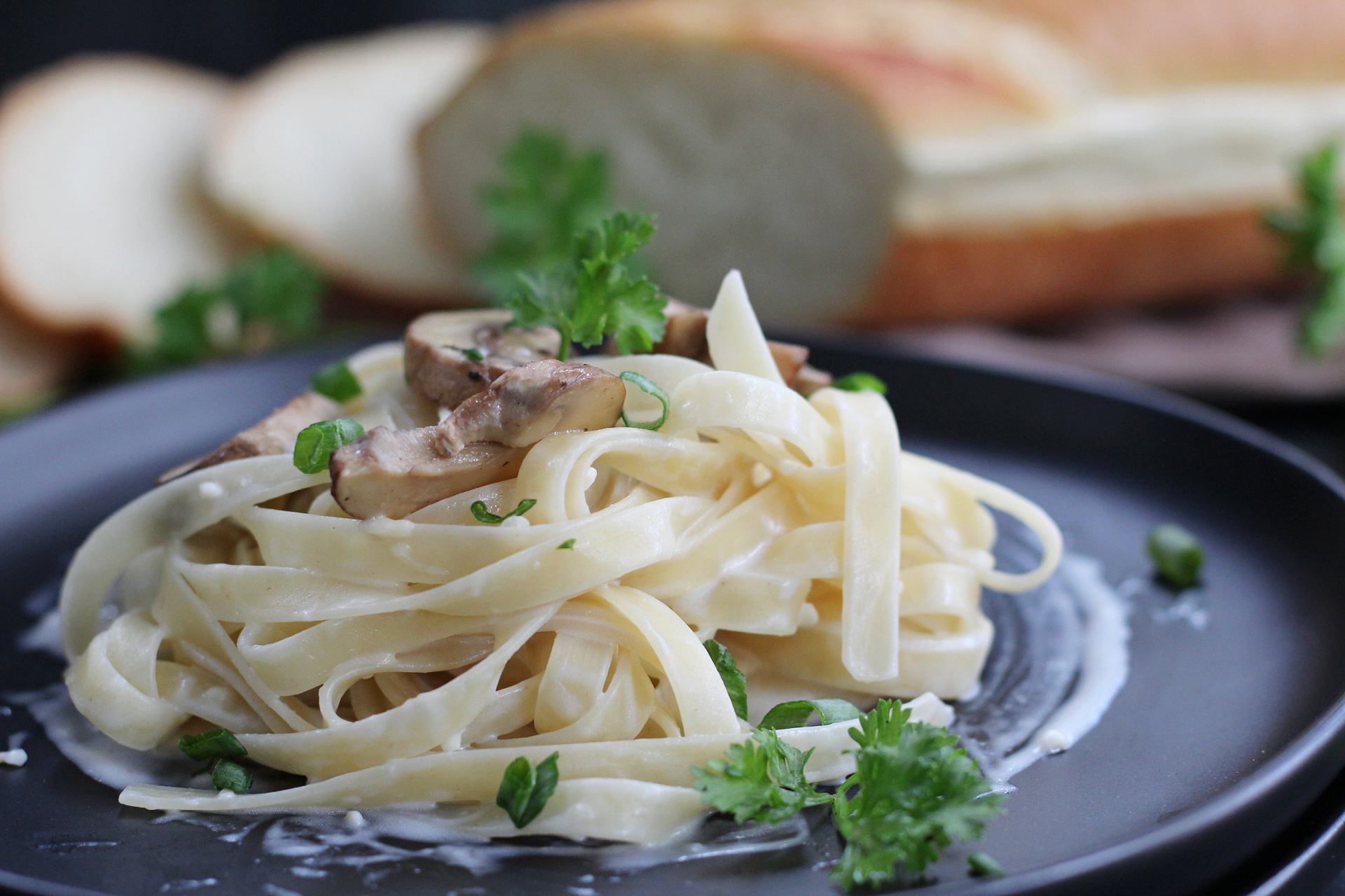 Creamy garlic Parmesan Alfredo sauce poured over cooked fettuccine