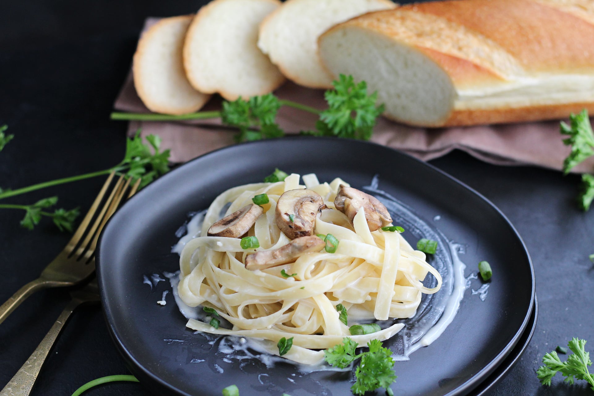 Close-up of mushroom Alfredo pasta topped with creamy sauce